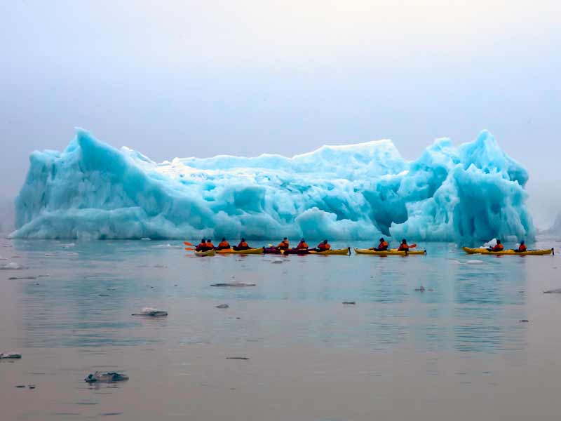 Kayakers near iceberg